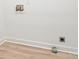 Laundry room hookups with modern flooring and base trim detail at 6201 New Hope Church Rd, Marshville, NC 28103