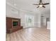 Inviting living room with fireplace, wood floors, and French doors leading to the backyard at 6201 New Hope Church Rd, Marshville, NC 28103