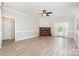 Inviting living room with fireplace, wood floors, and French doors leading to the backyard at 6201 New Hope Church Rd, Marshville, NC 28103