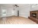 Open living room with brick fireplace, modern floors, and lots of light at 6201 New Hope Church Rd, Marshville, NC 28103