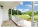 Inviting porch with white railing overlooking the expansive and verdant front yard at 6201 New Hope Church Rd, Marshville, NC 28103