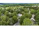 Expansive aerial view of a home nestled within a lush, tree-filled neighborhood and well manicured lawn at 641 Saratoga Dr, Clover, SC 29710