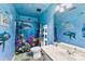 Whimsical bathroom decorated with blue walls, shark shower curtain, and ocean themed decorations at 641 Saratoga Dr, Clover, SC 29710