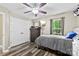 Bedroom featuring a ceiling fan, a TV mounted on the wall, closet, and gray wood floors at 641 Saratoga Dr, Clover, SC 29710