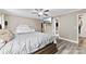 Well-lit bedroom features a ceiling fan, television, wood-look flooring, and neutral paint at 641 Saratoga Dr, Clover, SC 29710