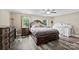 Spacious bedroom featuring a large bed, gray wood floors, dresser, and a crib at 641 Saratoga Dr, Clover, SC 29710