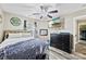Bedroom features wood floors, a ceiling fan, dresser, and a TV mounted on the wall at 641 Saratoga Dr, Clover, SC 29710