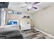 Bedroom featuring a ceiling fan, wall decor, and gray wood floors at 641 Saratoga Dr, Clover, SC 29710