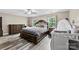 Spacious bedroom with a large bed, gray wood floors, dresser, and a crib at 641 Saratoga Dr, Clover, SC 29710