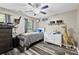 Cozy bedroom with gray wood floors, a ceiling fan, and a wall with shelves and a giraffe at 641 Saratoga Dr, Clover, SC 29710