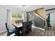 Cozy dining area with a dark wood table, colorful chairs, and a view of the backyard through the window at 641 Saratoga Dr, Clover, SC 29710