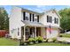 Well-maintained two-story home featuring an attached garage, inviting front porch, and landscaped front yard at 641 Saratoga Dr, Clover, SC 29710