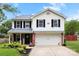 Charming two-story home with a well-manicured lawn, attached garage, and a welcoming front porch at 641 Saratoga Dr, Clover, SC 29710