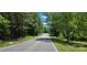 Scenic street view with lush greenery on either side, showcasing the natural beauty of the surroundings at 6653 Mountain Grove Rd, Hickory, NC 28658