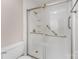 A newly renovated bathroom featuring a tiled shower with glass doors and grab bars at 7026 Quail Hill Rd, Charlotte, NC 28210