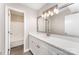 Bright bathroom with a long vanity, quartz countertop, and access to a tub shower at 7026 Quail Hill Rd, Charlotte, NC 28210
