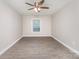 A spacious bedroom featuring updated flooring, ceiling fan, and a bright window at 7026 Quail Hill Rd, Charlotte, NC 28210
