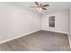 Neutral bedroom with laminate flooring, a window, and a ceiling fan at 7026 Quail Hill Rd, Charlotte, NC 28210