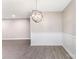 Bright dining area featuring laminate flooring and modern light fixture at 7026 Quail Hill Rd, Charlotte, NC 28210