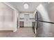 Modern kitchen featuring stainless steel appliances, white cabinets, and laminate flooring at 7026 Quail Hill Rd, Charlotte, NC 28210
