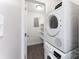 Compact laundry room equipped with a stacked washer and dryer unit at 7026 Quail Hill Rd, Charlotte, NC 28210