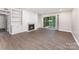Bright living room featuring a fireplace, built-in shelving, and sliding glass doors to the outside at 7026 Quail Hill Rd, Charlotte, NC 28210