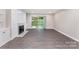 Spacious living room with a fireplace, built-in shelving, and sliding glass doors to the outside at 7026 Quail Hill Rd, Charlotte, NC 28210