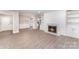 Living room featuring a fireplace with built-in shelving, and laminate floors at 7026 Quail Hill Rd, Charlotte, NC 28210