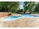 Community swimming pool with lounge chairs surrounded by lush greenery, perfect for relaxation at 7026 Quail Hill Rd, Charlotte, NC 28210