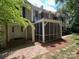 Charming townhouse featuring a screened porch and second-story balcony, surrounded by mature trees at 7026 Quail Hill Rd, Charlotte, NC 28210