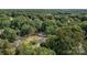 An aerial view of a house surrounded by green trees and roads at 800 Woodlawn St, Belmont, NC 28012