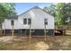 Back exterior of house with a dark painted basement and backyard at 800 Woodlawn St, Belmont, NC 28012