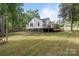 Back exterior of house with a wooden deck and unfinished yard at 800 Woodlawn St, Belmont, NC 28012