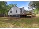 Back exterior of house with a wooden deck and unfinished yard at 800 Woodlawn St, Belmont, NC 28012