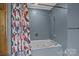 Cozy bathroom featuring bathtub with showerhead and patterned shower curtain at 800 Woodlawn St, Belmont, NC 28012