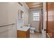 Small bathroom featuring vanity, toilet and shower with tan and white tiled floor at 800 Woodlawn St, Belmont, NC 28012