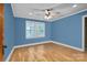 Empty bedroom with hardwood floors, ceiling fan and two windows at 800 Woodlawn St, Belmont, NC 28012