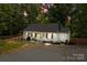 Inviting home exterior featuring a cozy porch swing, landscaped yard, and outdoor lighting for evening ambiance at 800 Woodlawn St, Belmont, NC 28012