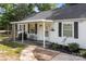 Attractive home exterior with a covered porch, black shutters, and landscaping, offering a blend of comfort and appeal at 800 Woodlawn St, Belmont, NC 28012