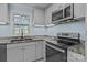 Well-lit kitchen features granite countertops, stainless steel appliances, and ample cabinet space at 800 Woodlawn St, Belmont, NC 28012