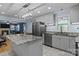 Open-concept kitchen with stainless steel appliances and an island, blending functionality with a modern, stylish design at 800 Woodlawn St, Belmont, NC 28012