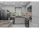 Well-lit kitchen featuring stainless steel appliances, granite countertops, tile backsplash, and center island at 800 Woodlawn St, Belmont, NC 28012