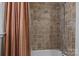 Shower with a patterned shower curtain and tiled walls and shower head at 800 Woodlawn St, Belmont, NC 28012