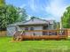 Exterior home shot showcasing a wooden deck, green lawn, and backyard at 827 Fairbanks Rd, Charlotte, NC 28210