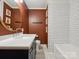 Bathroom with a vanity, white subway tile, and earth-tone accent wall at 827 Fairbanks Rd, Charlotte, NC 28210