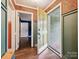 Bright foyer features stylish wallpaper, beautiful hardwood flooring, and ample natural light at 827 Fairbanks Rd, Charlotte, NC 28210