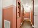 Hallway features built-in shelves, hardwood floors, and neutral paint scheme at 827 Fairbanks Rd, Charlotte, NC 28210