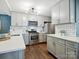 This kitchen features stainless steel appliances, gray cabinets, a subway tile backsplash, and an island at 827 Fairbanks Rd, Charlotte, NC 28210