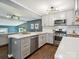 This updated kitchen boasts custom cabinets, quartz countertops, stainless appliances, and a breakfast bar at 827 Fairbanks Rd, Charlotte, NC 28210