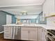 A sleek kitchen features stainless steel appliances, light gray cabinetry, and an adjacent dining area at 827 Fairbanks Rd, Charlotte, NC 28210